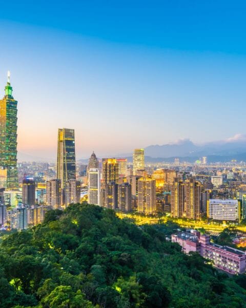 Vietnam Construction Market Outlook 2025: Twilight cityscape with a distinctive skyscraper and mountain backdrop.